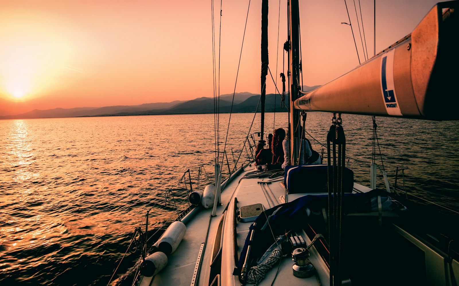 Sailboat deck under sail at sunset