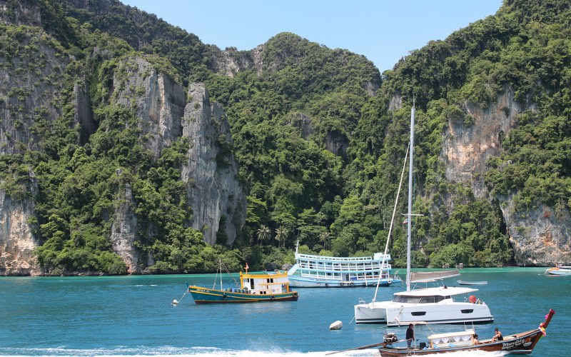 Tour boats anchored in a tropical island bay
